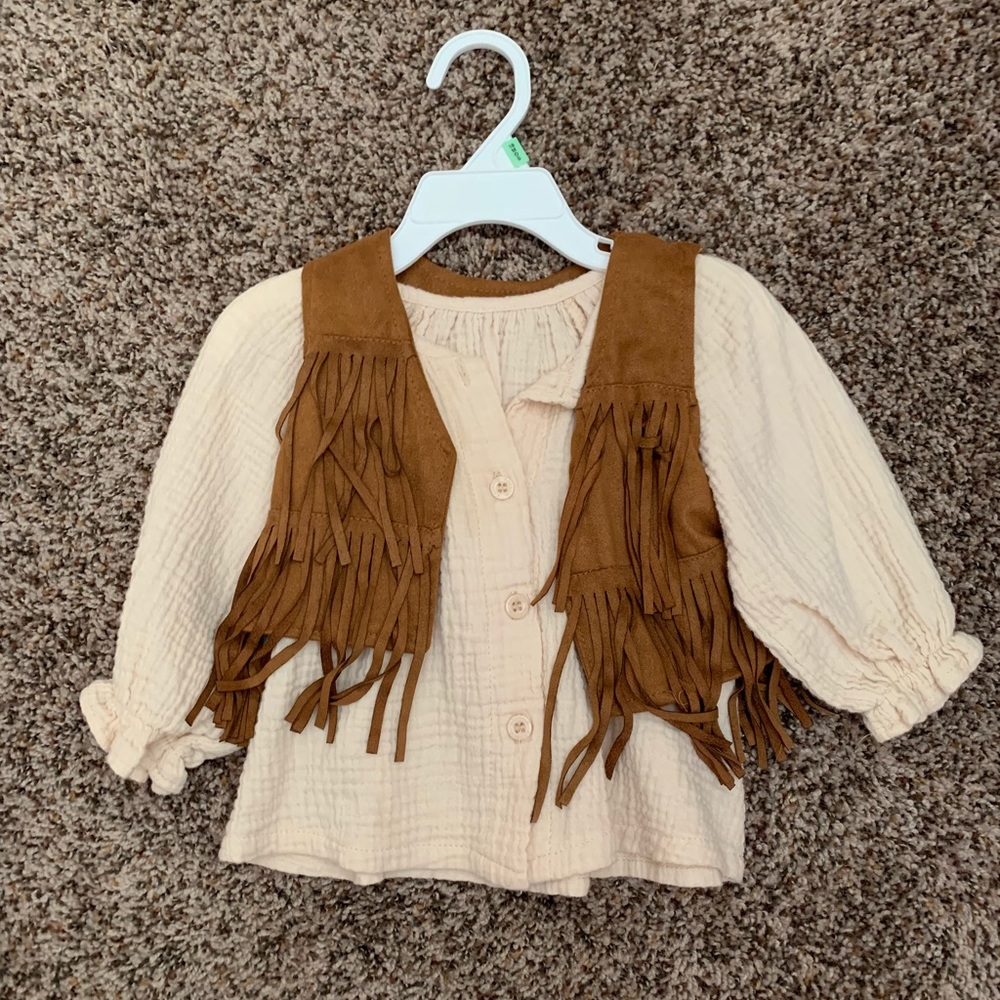 off while button down shirt with tan fringe vest.